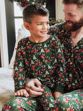 Step into the magic of the season with our Mystic Forest unisex fitted pajamas. Featuring a charming woodland-inspired print with evergreen trees and forest details, this holiday pajama set brings a touch of winter wonder to cozy nights. Made from soft, stretchy fabric for a snug yet comfortable fit, these fitted Christmas pajamas are perfect for lounging, sleeping, or matching family holiday photos.